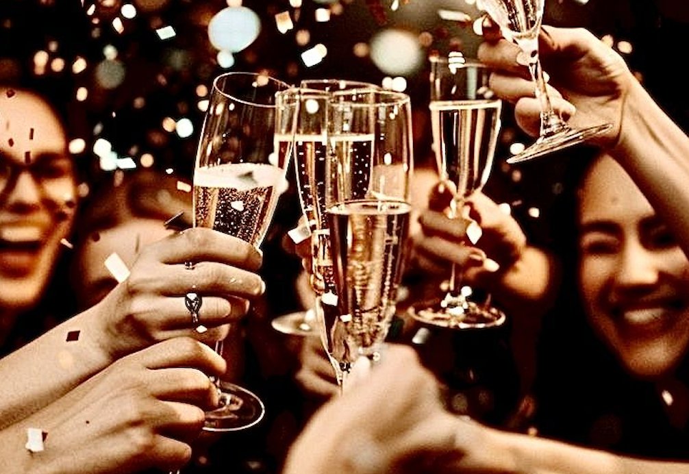 Friends raising champagne glasses in a celebration toast